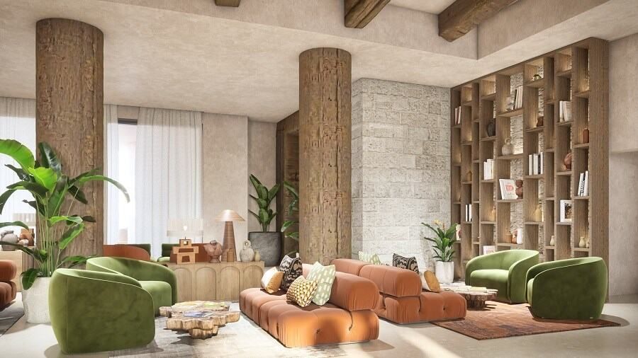 לובי מלון כנען המעוצב באווירה חמימה וטבעית, עם ספות מרופדות בגווני חום וירוק