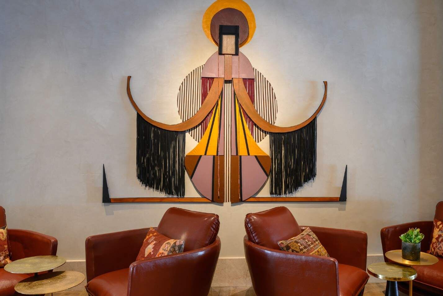 טרקלין יוקרתי עם כורסאות עור חומות ושולחנות צד קטנים, מעוצב בסגנון מודרני